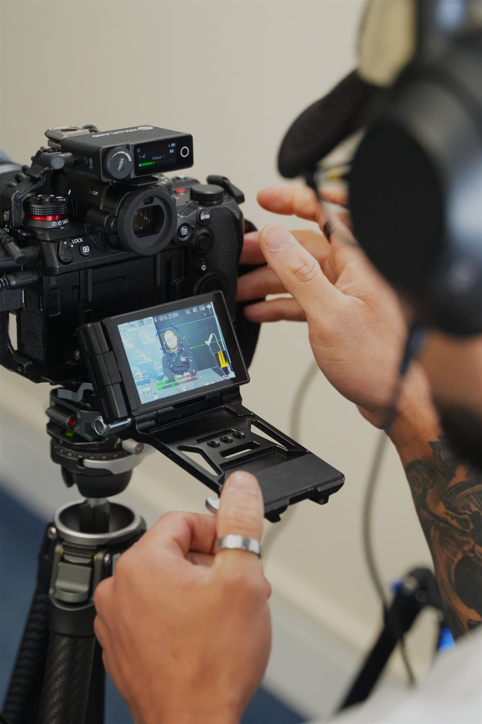 Enriko checking a cinema camera during a client shoot