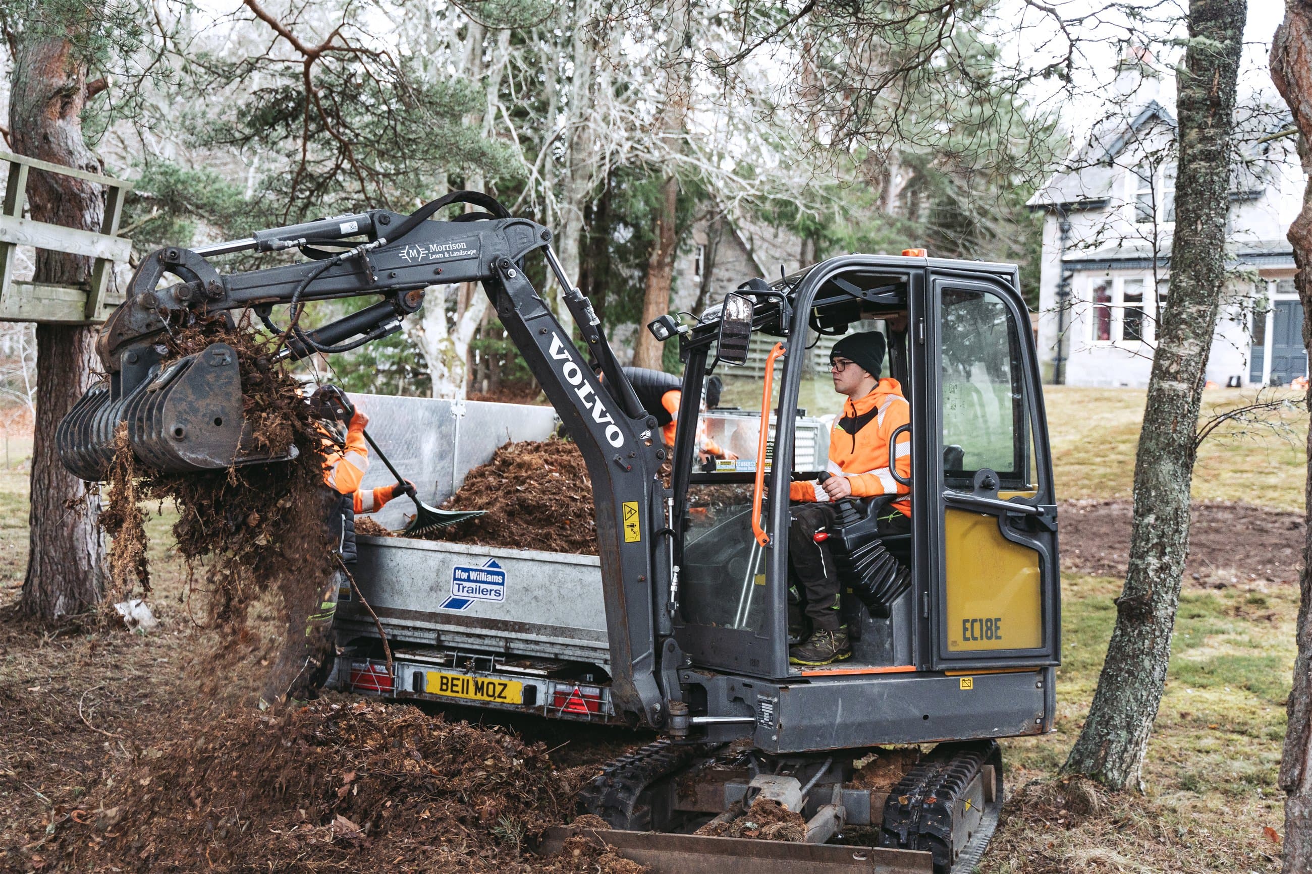 Landscaping team operating a mini excavator on a Highland estate