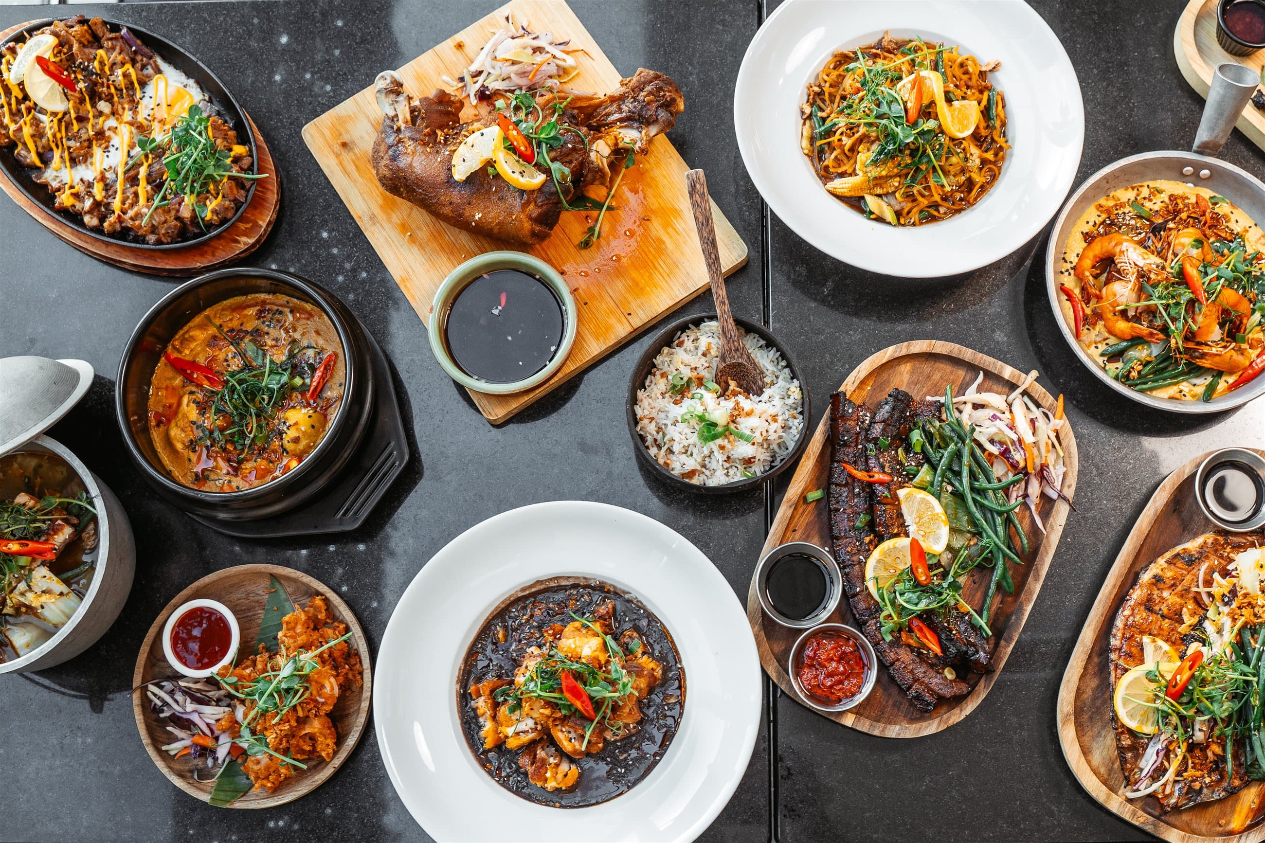 Colourful restaurant dishes arranged across a table
