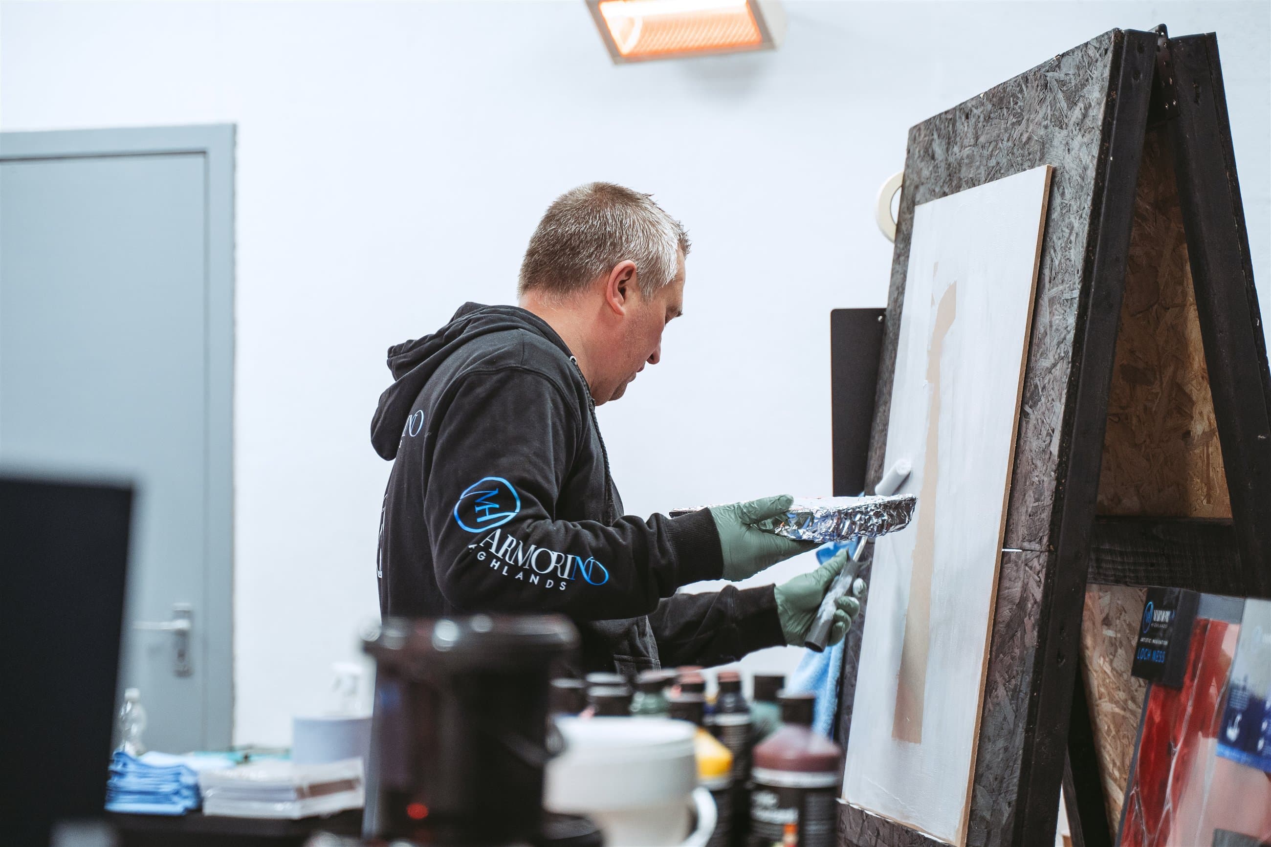 Specialist craftsperson applying a spray finish in a workshop